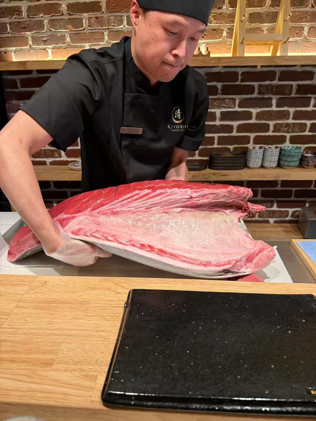 Kiyoshi Omakase chef presenting whole bluefin tuna loin at Overland Park counter