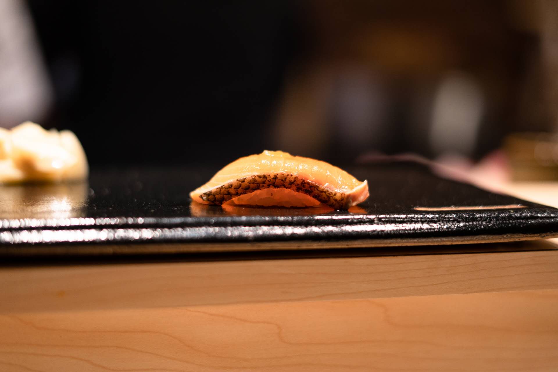 Salmon nigiri on black slate plate at Kiyoshi Omakase