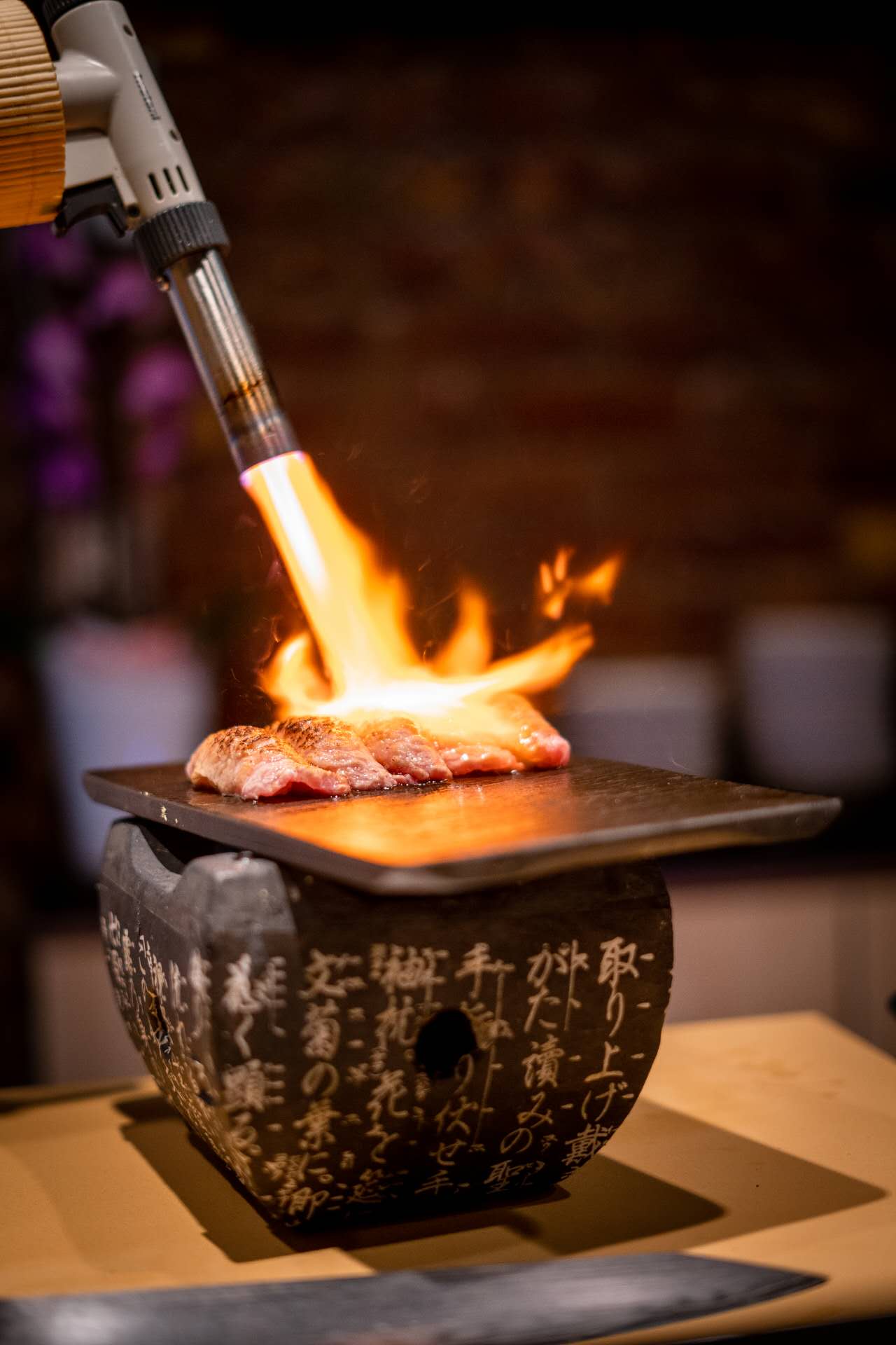 Chef torching wagyu beef during live sushi performance at Kiyoshi Omakase Overland Park KS